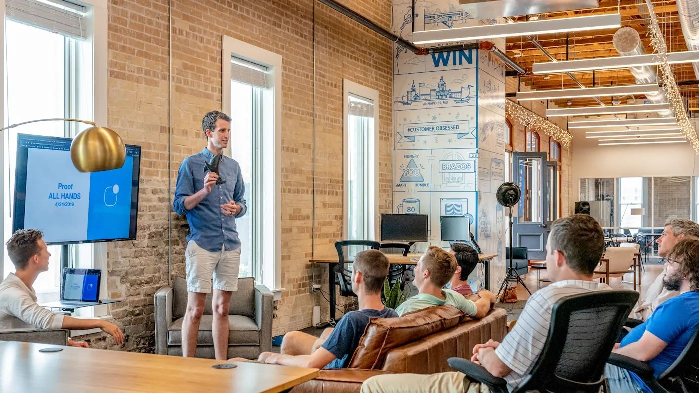 A modern Canadian team collaborating around a laptop in an open office